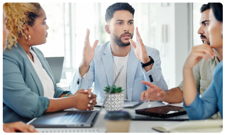 A group of people sitting at a table

AI-generated content may be incorrect.